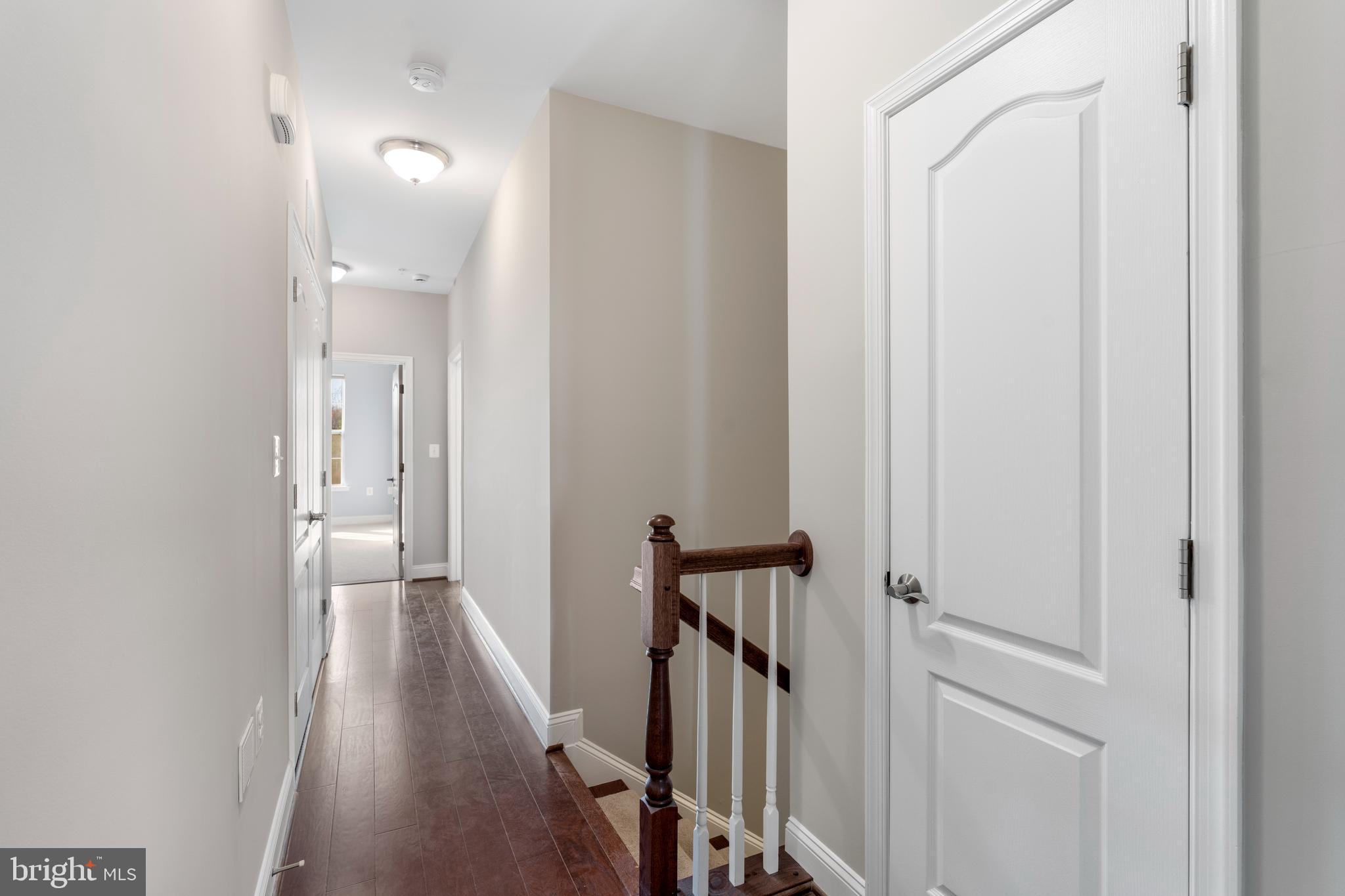 11246 Chase Street, Unit 141 Fulton, MD 20759 - Photo 20 of 37 a view of a hallway with wooden floor and staircase