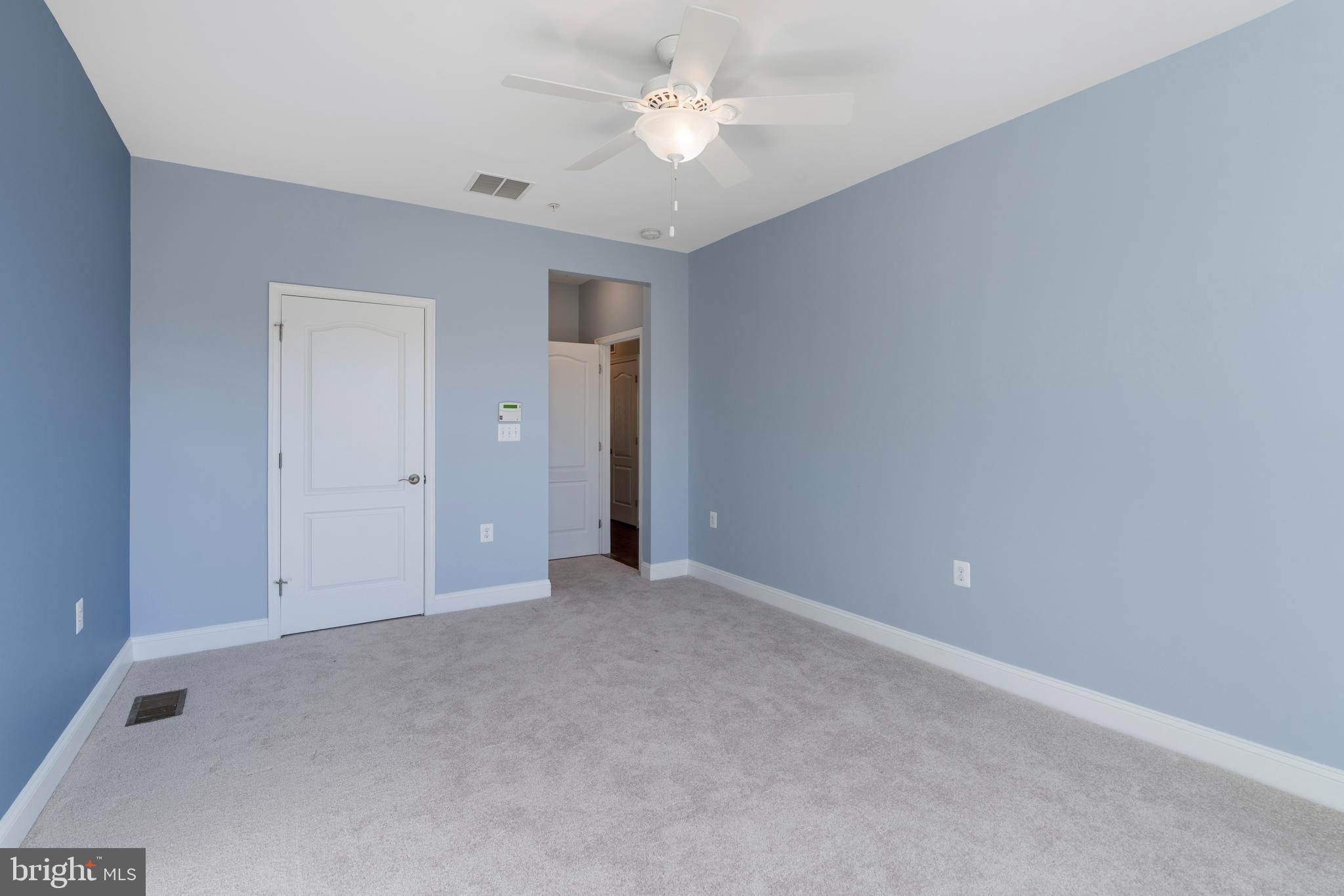 11246 Chase Street, Unit 141 Fulton, MD 20759 - Photo 24 of 37 a view of an empty room with a ceiling fan