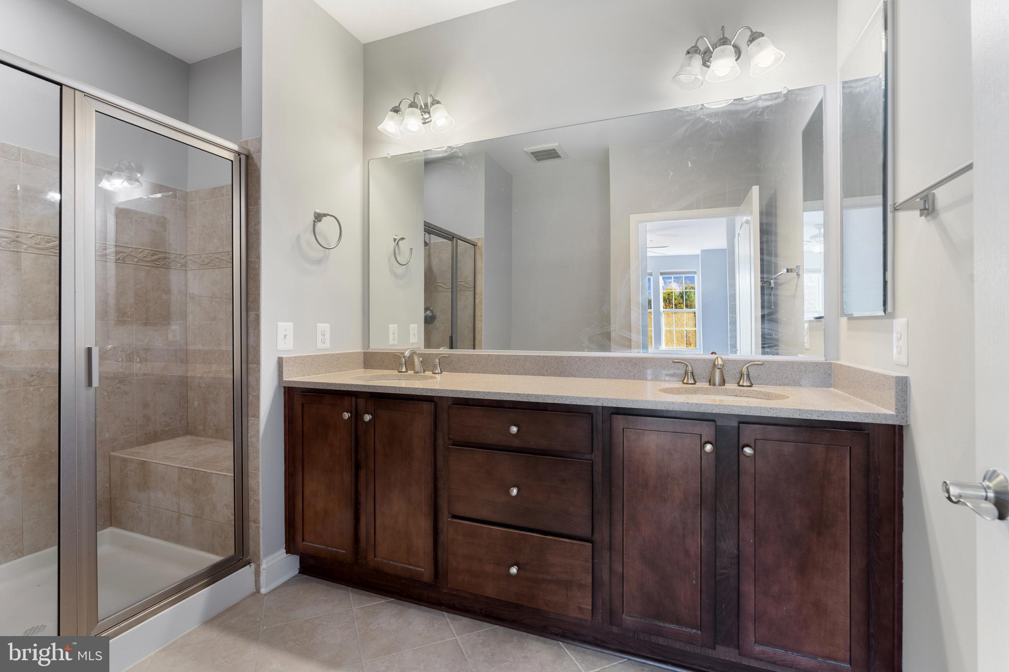 11246 Chase Street, Unit 141 Fulton, MD 20759 - Photo 26 of 37 a bathroom with a granite countertop sink mirror and shower