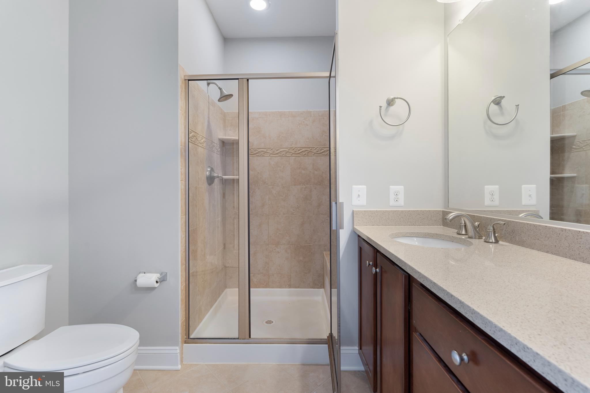 11246 Chase Street, Unit 141 Fulton, MD 20759 - Photo 27 of 37 a bathroom with a granite countertop sink toilet and shower