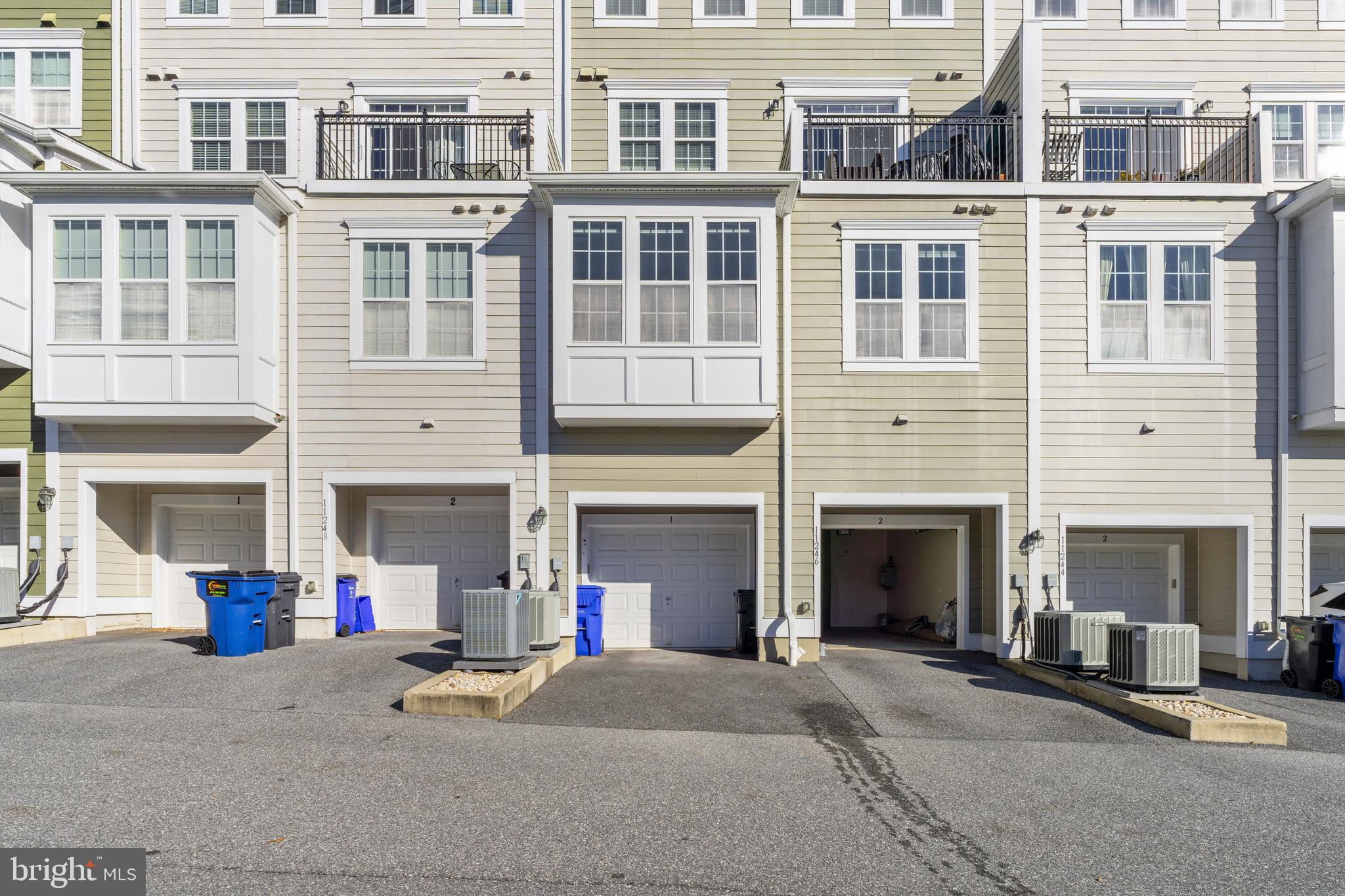 11246 Chase Street, Unit 141 Fulton, MD 20759 - Photo 35 of 37 a front view of a building with a parking space and a garage