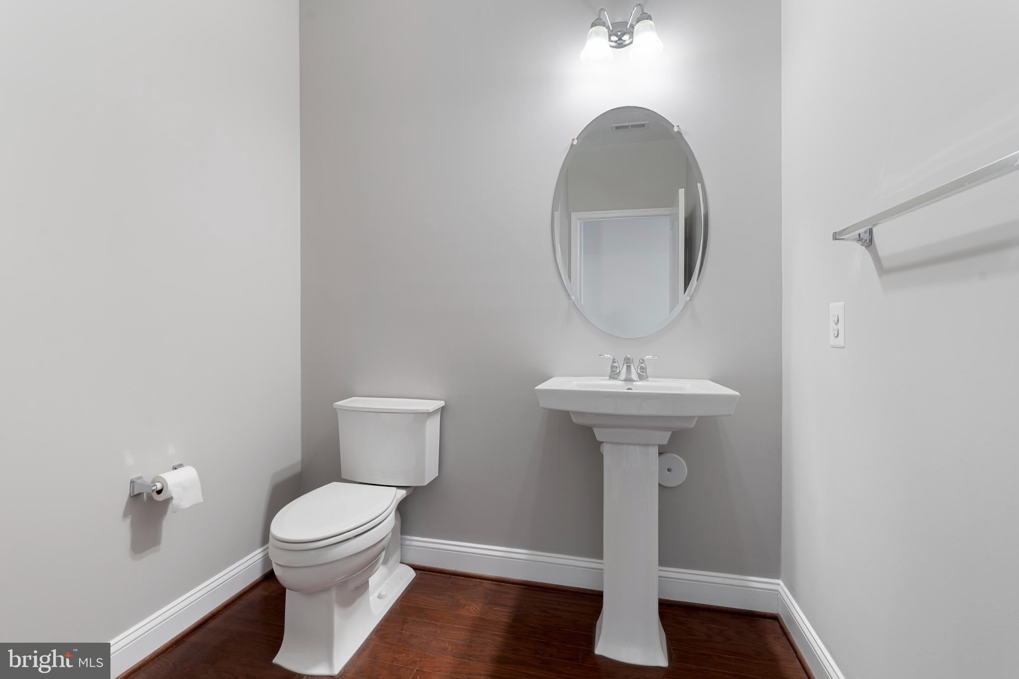 11246 Chase Street, Unit 141 Fulton, MD 20759 - Photo 9 of 37 a bathroom with a toilet a sink and a mirror