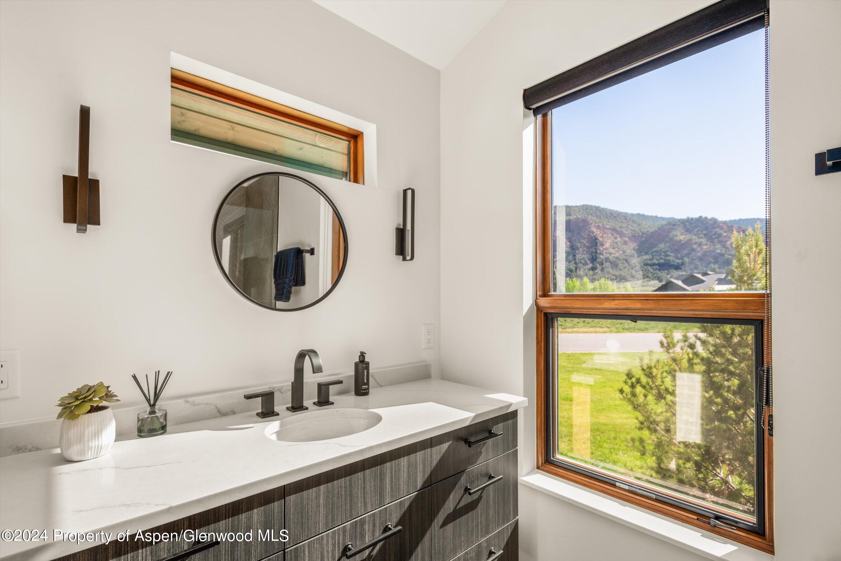 16 Puma Carbondale, CO 81623 - Photo 14 of 21 a bathroom with a granite countertop sink and a large mirror