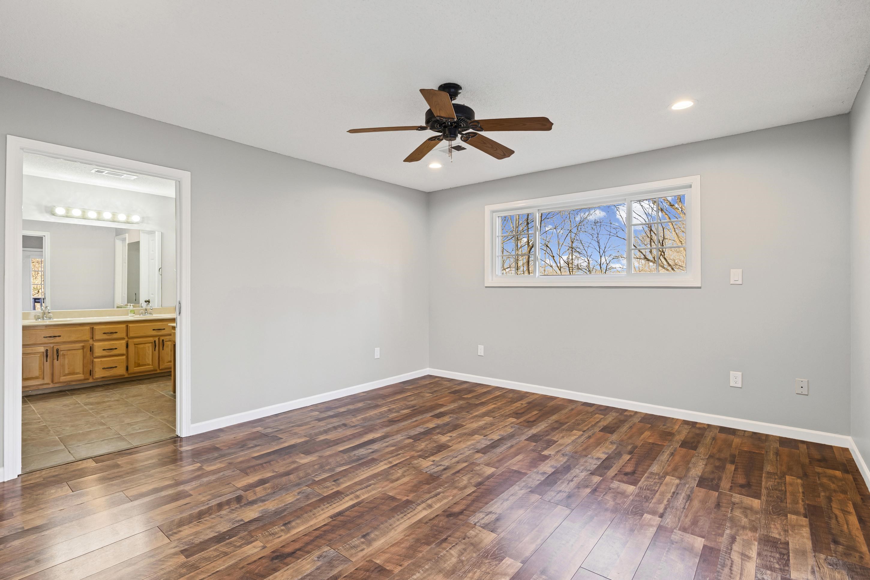 225 Poplar Grove Church Road Drummonds, TN 38023 - Photo 12 of 30 wooden floor in an empty room with a window