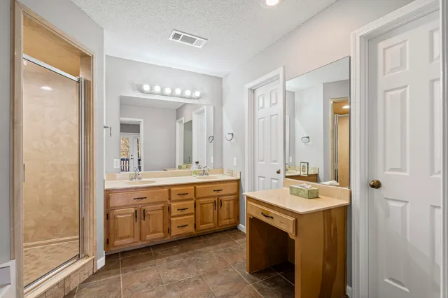 a spacious bathroom with a double vanity sink mirror and double