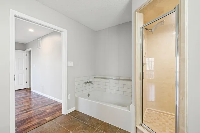 a bathroom with a bathtub and a shower