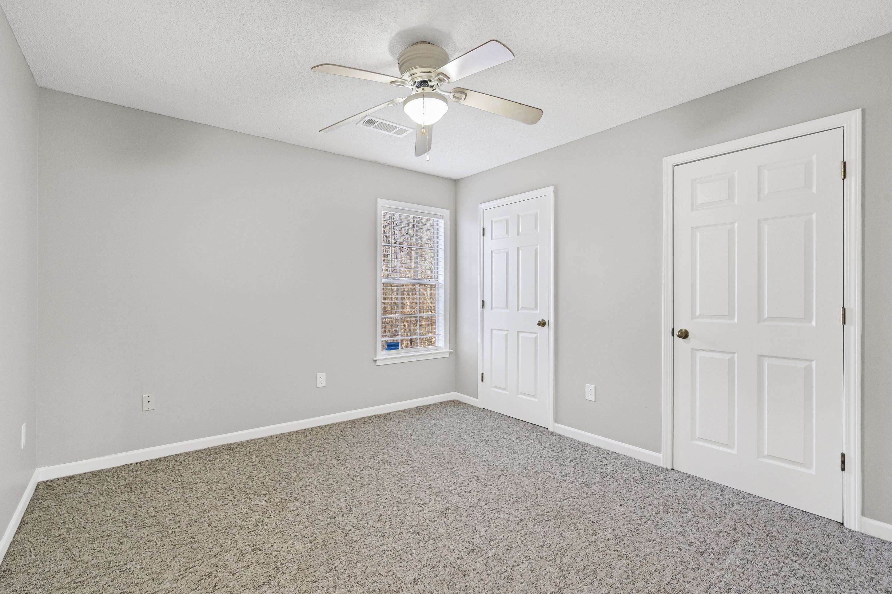 225 Poplar Grove Church Road Drummonds, TN 38023 - Photo 17 of 30 a view of an empty room with a ceiling fan