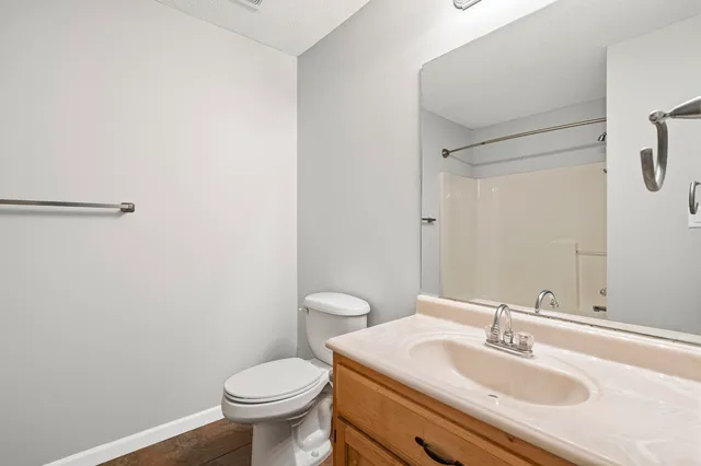 a bathroom with a sink toilet and a mirror