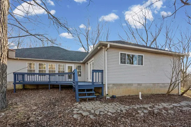 a backyard of a house with barbeque oven and outdoor seating