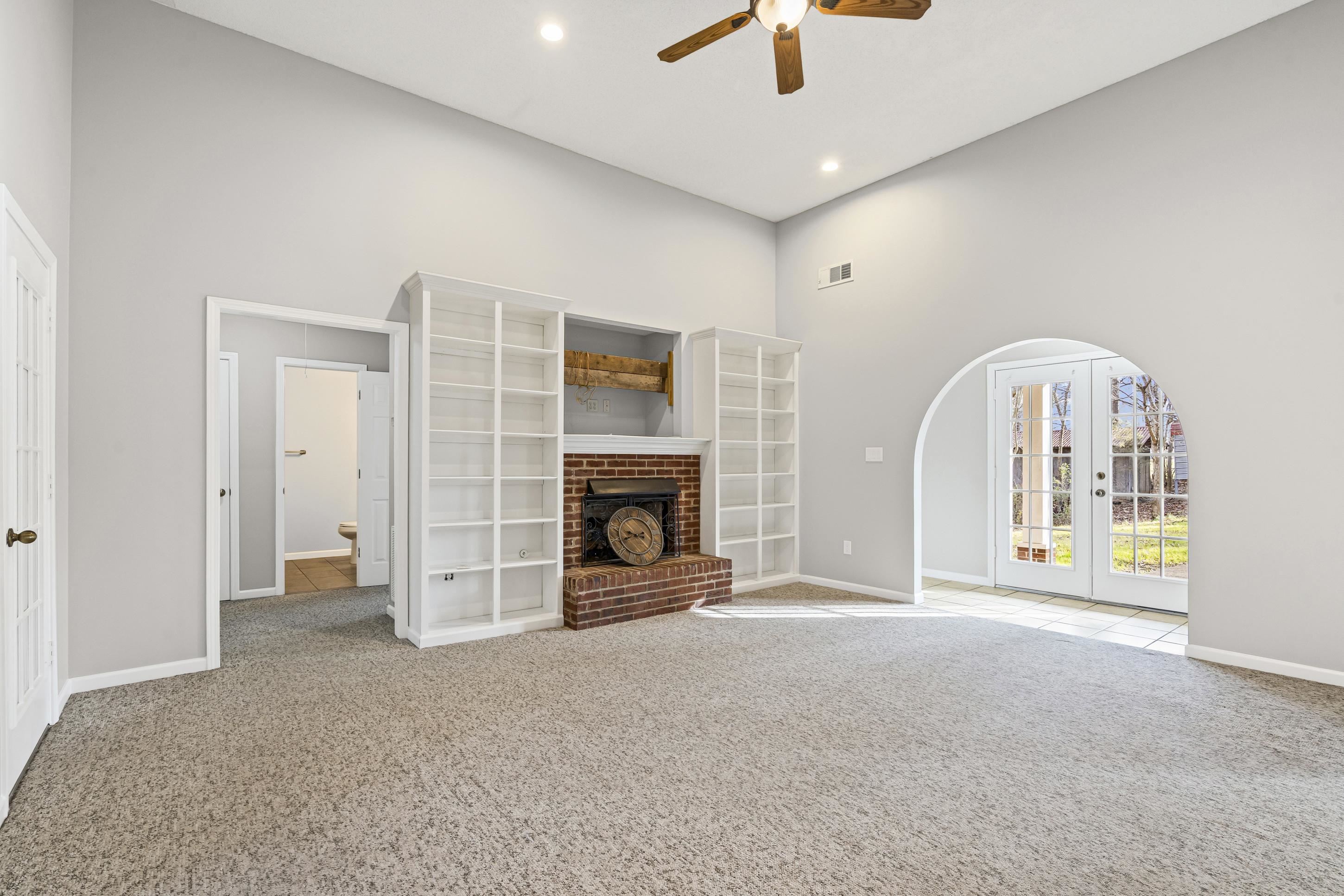 225 Poplar Grove Church Road Drummonds, TN 38023 - Photo 5 of 30 an empty room with fireplace and windows