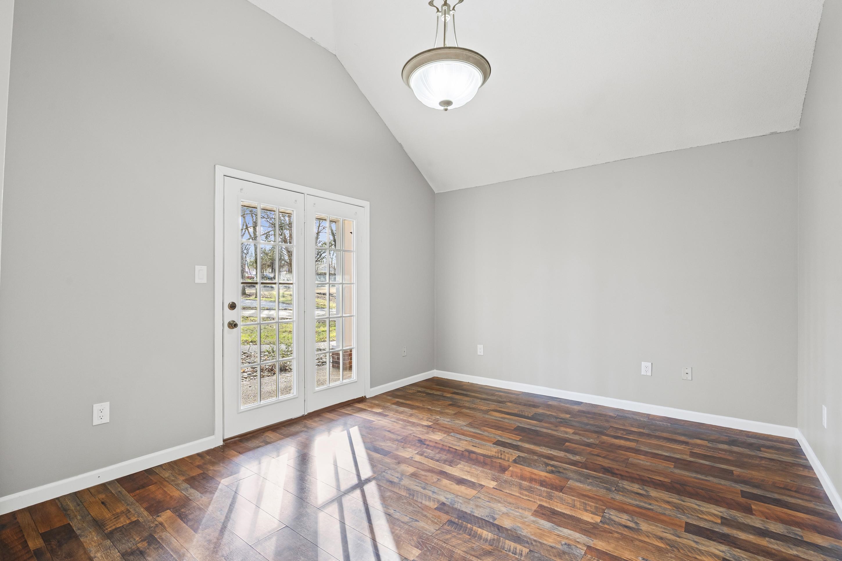 225 Poplar Grove Church Road Drummonds, TN 38023 - Photo 6 of 30 a view of an empty room with wooden floor and windows