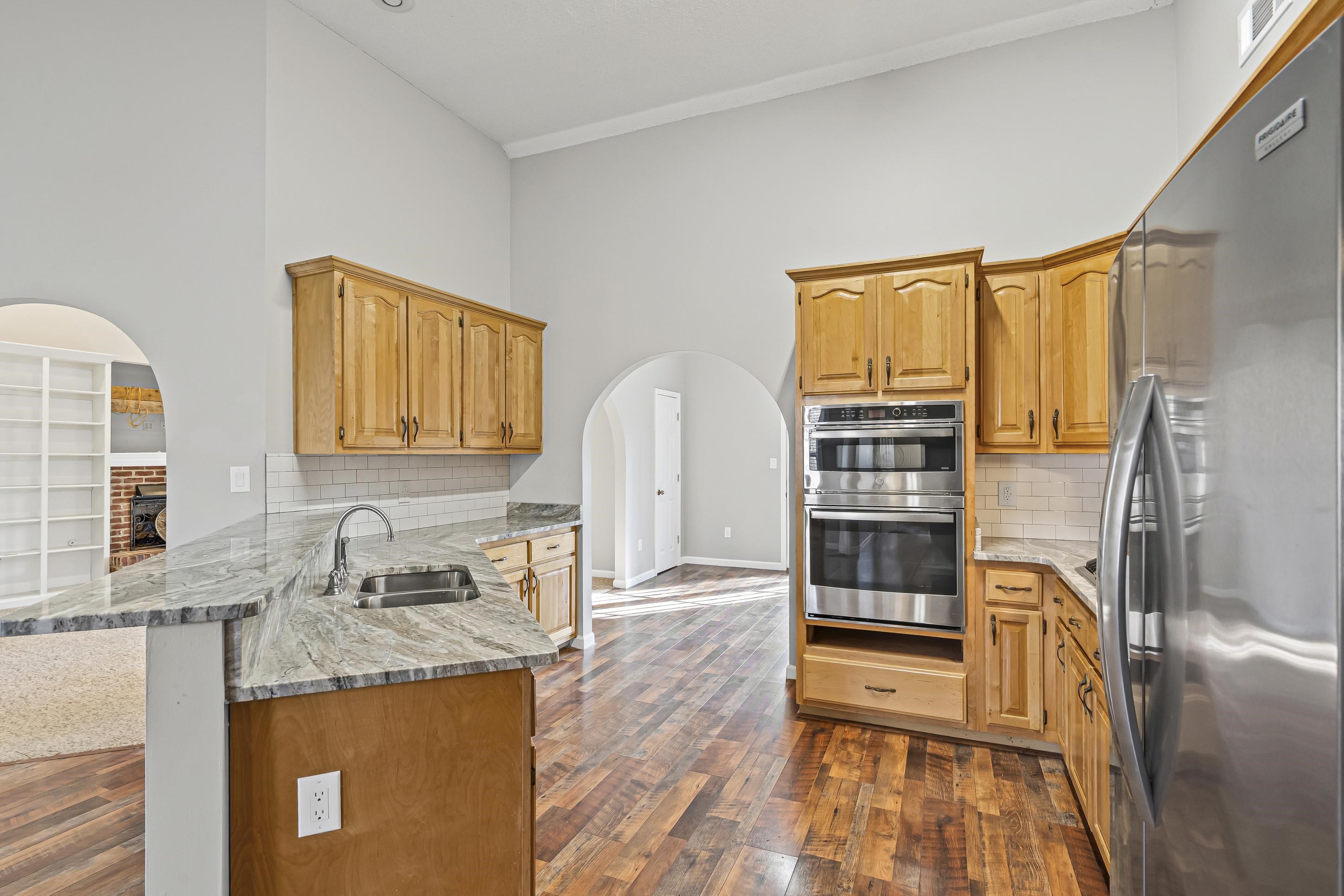 225 Poplar Grove Church Road Drummonds, TN 38023 - Photo 9 of 30 a kitchen with stainless steel appliances granite countertop a stove a sink and a refrigerator
