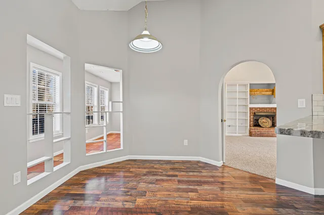a view of a livingroom with wooden floor and a window