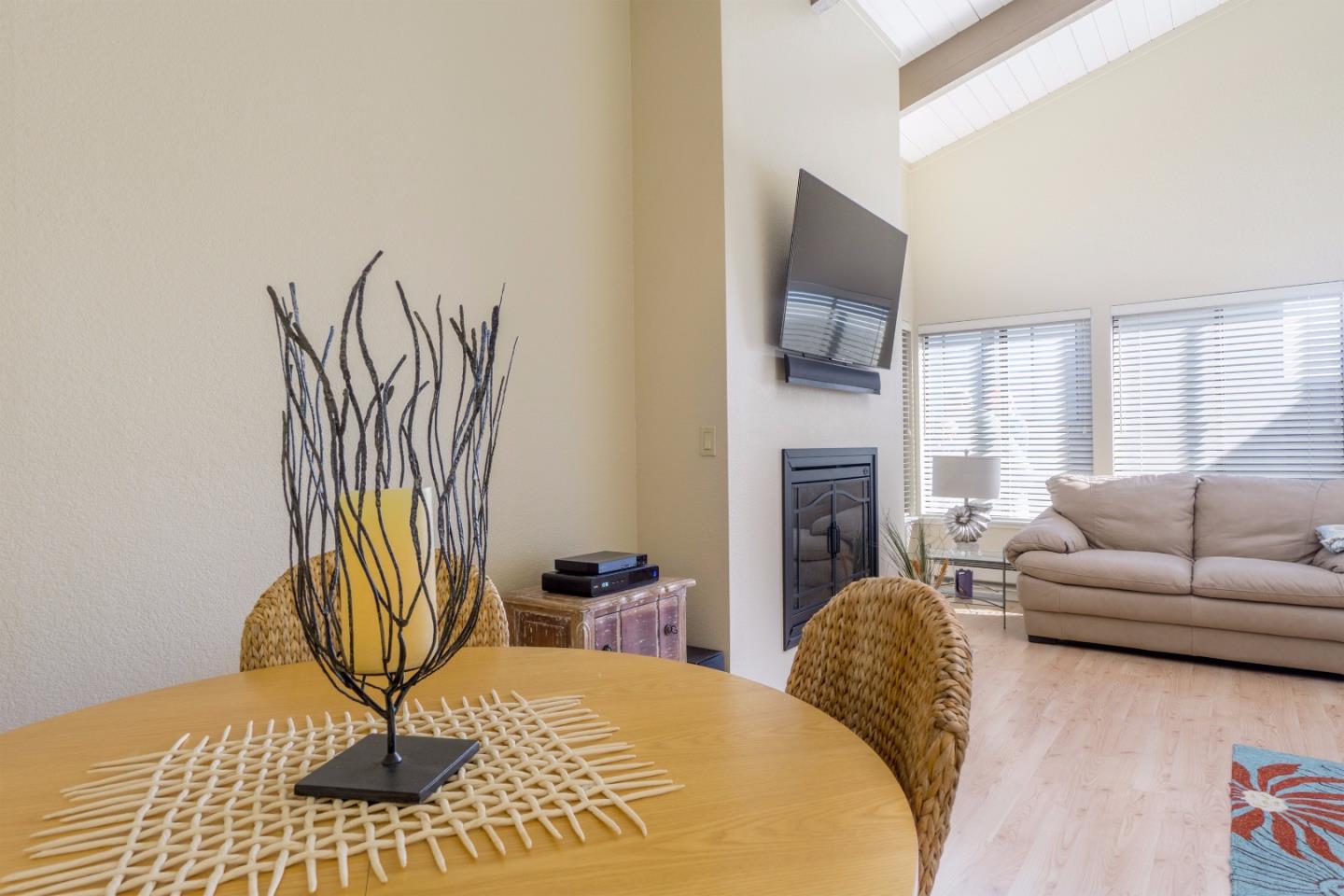 1 Surf Way, Unit 228 Monterey, CA 93940 - Photo 6 of 13 a living room with furniture and a fireplace