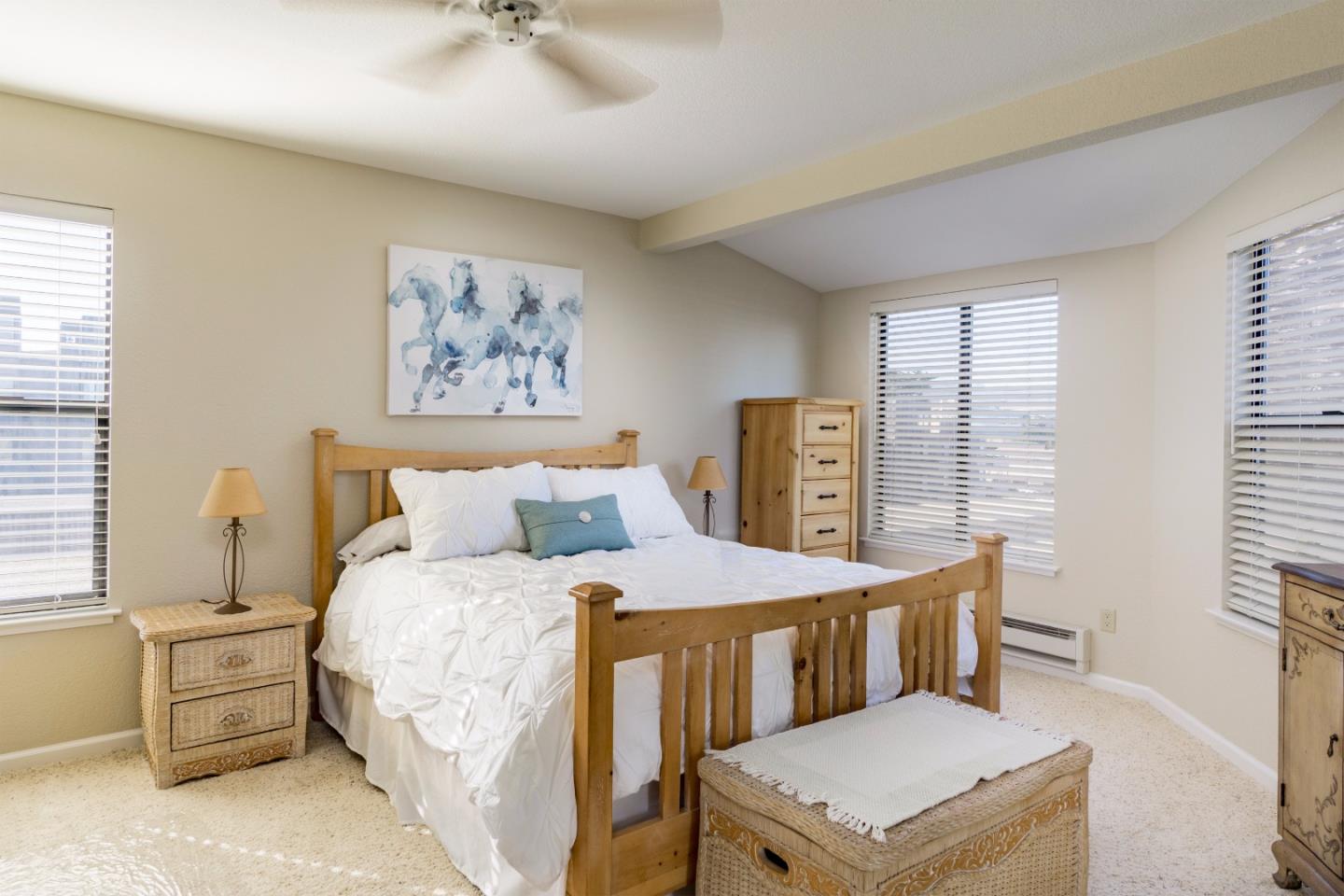 1 Surf Way, Unit 228 Monterey, CA 93940 - Photo 7 of 13 a bedroom with a bed and a table