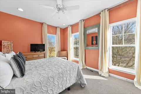 a bedroom with a large bed and a couch