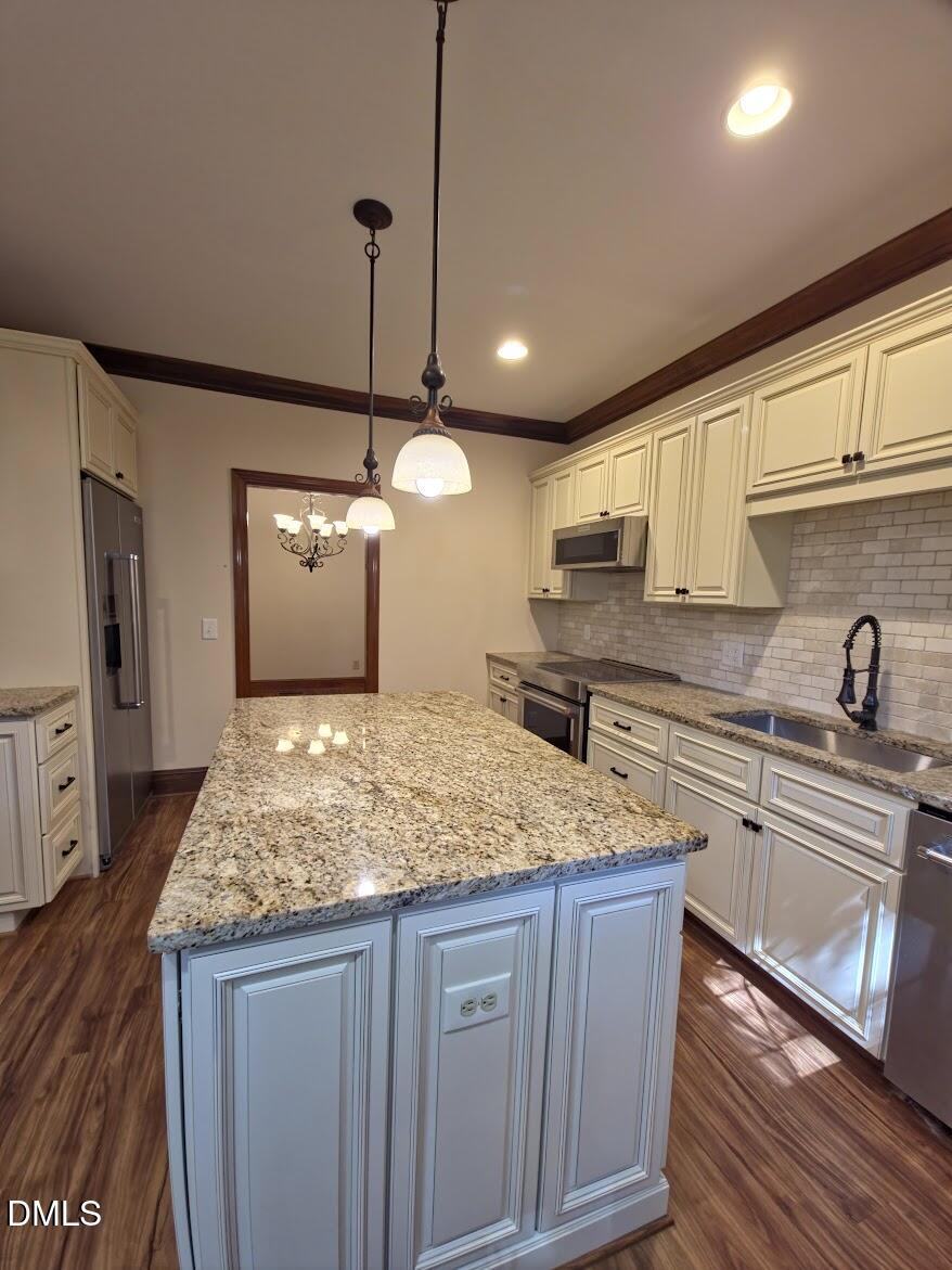 6844 Gloucester Road Raleigh, NC 27612 - Photo 4 of 25 a kitchen with stainless steel appliances granite countertop a sink a stove and a wooden floors