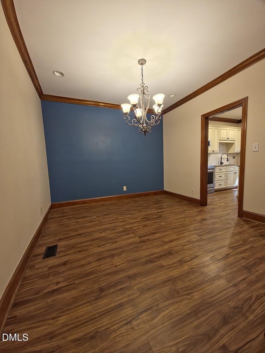 6844 Gloucester Road Raleigh, NC 27612 - Photo 6 of 25 a view of a livingroom with wooden floor