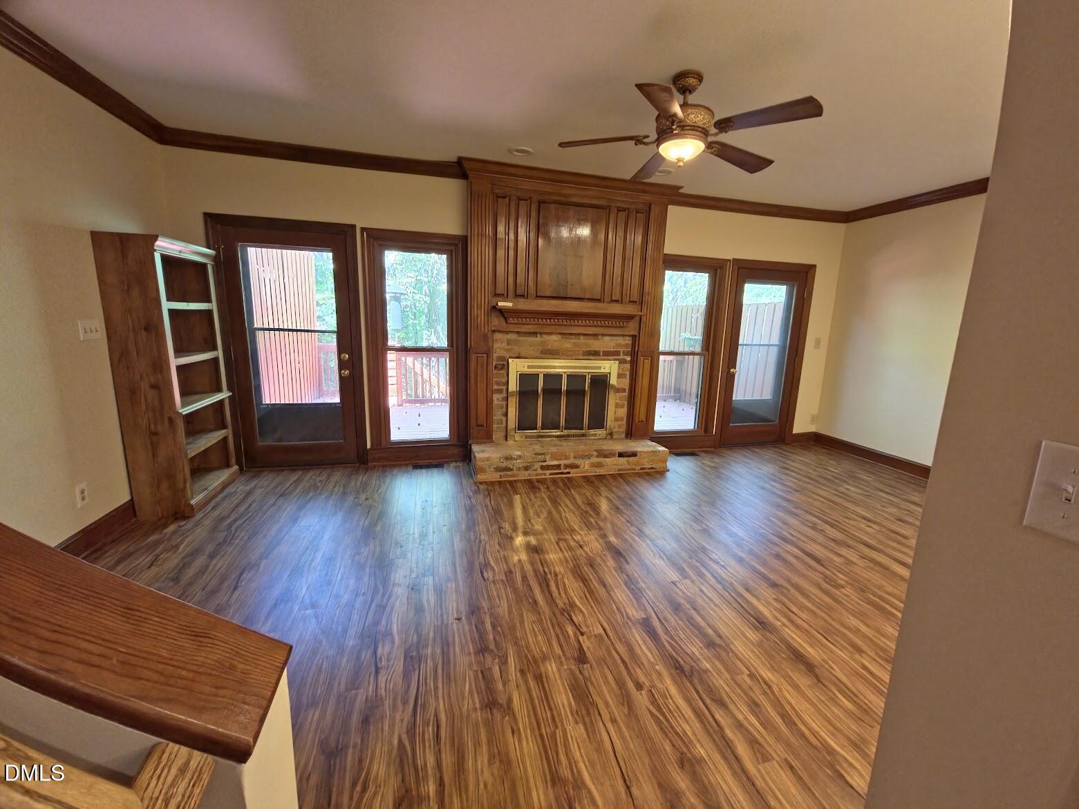 6844 Gloucester Road Raleigh, NC 27612 - Photo 7 of 25 a view of an empty room with wooden floor and a window