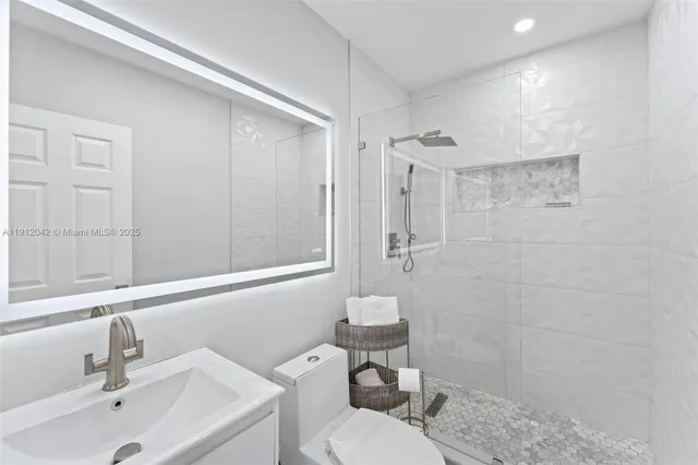 a bathroom with a sink toilet and shower