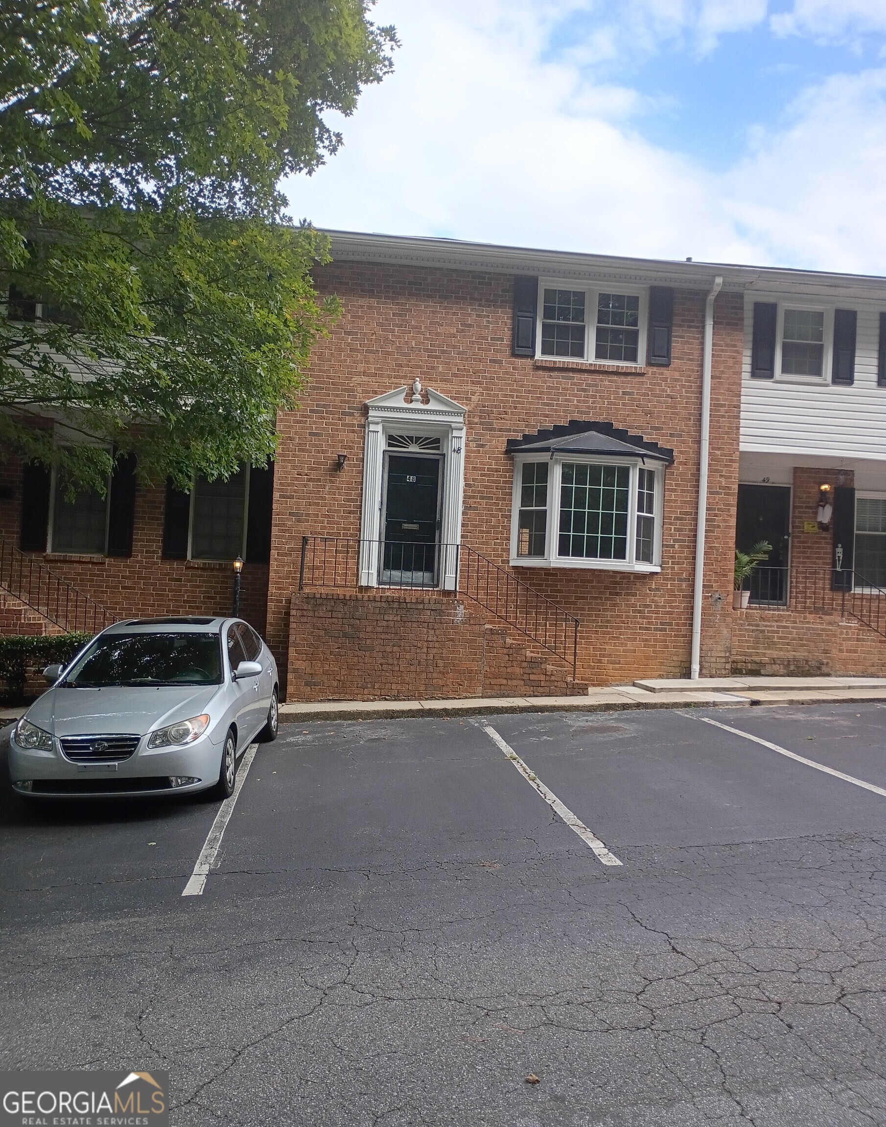 6520 Roswell Road, Unit 48 Atlanta, GA 30328 - Photo 1 of 1 a car parked in front of a house