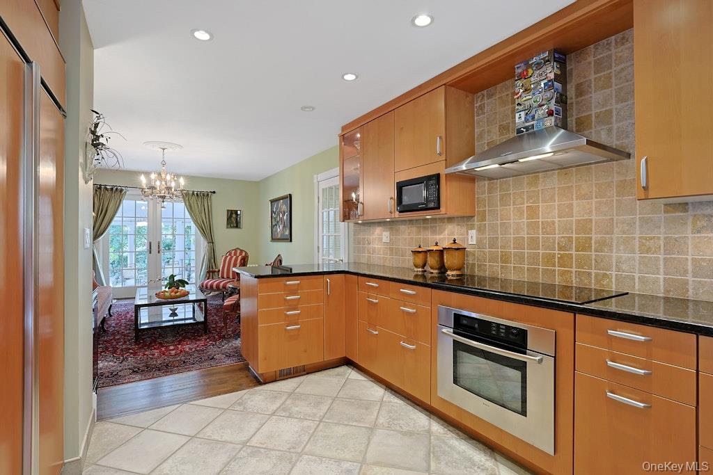 97 Underhill Road Scarsdale, NY 10583 - Photo 7 of 39 a kitchen with stainless steel appliances granite countertop a sink and cabinets