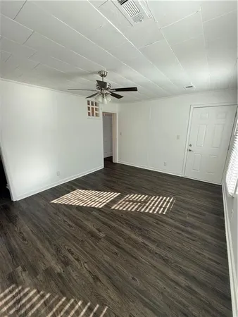 a view of a room with wooden floor