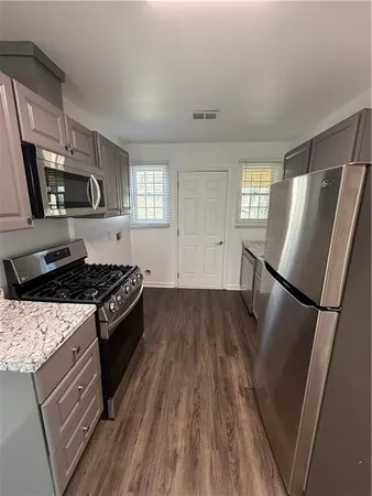 a kitchen with wooden floors and a stove