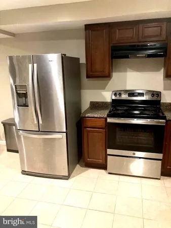 a kitchen with cabinets and stainless steel appliances