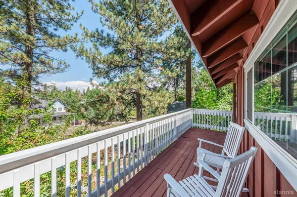 a view of balcony with wooden floor and fence