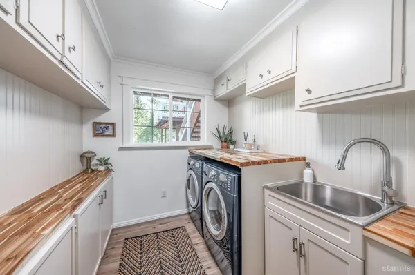 a utility room with sink dryer and washer