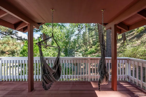 a view of a deck with a floor to ceiling window and wooden floor