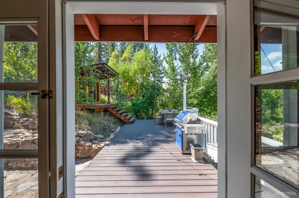 a view of a porch with wooden floor and a yard