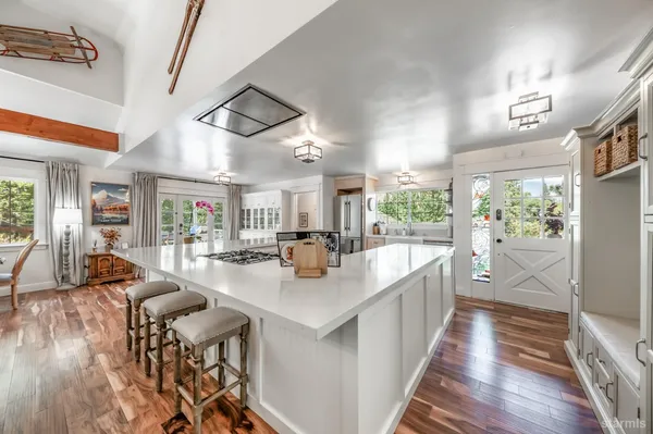 a view of a living room and kitchen with furniture wooden floor