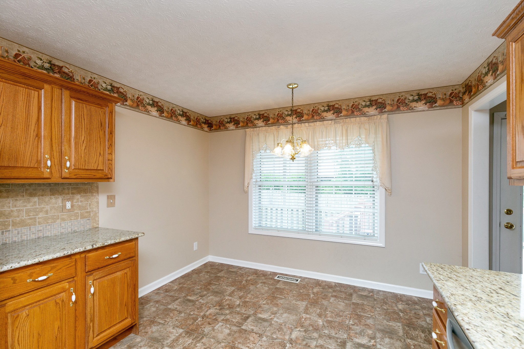 121 Foxrun Springfield, TN 37172 - Photo 14 of 36 a view of a kitchen with wooden floor and a window