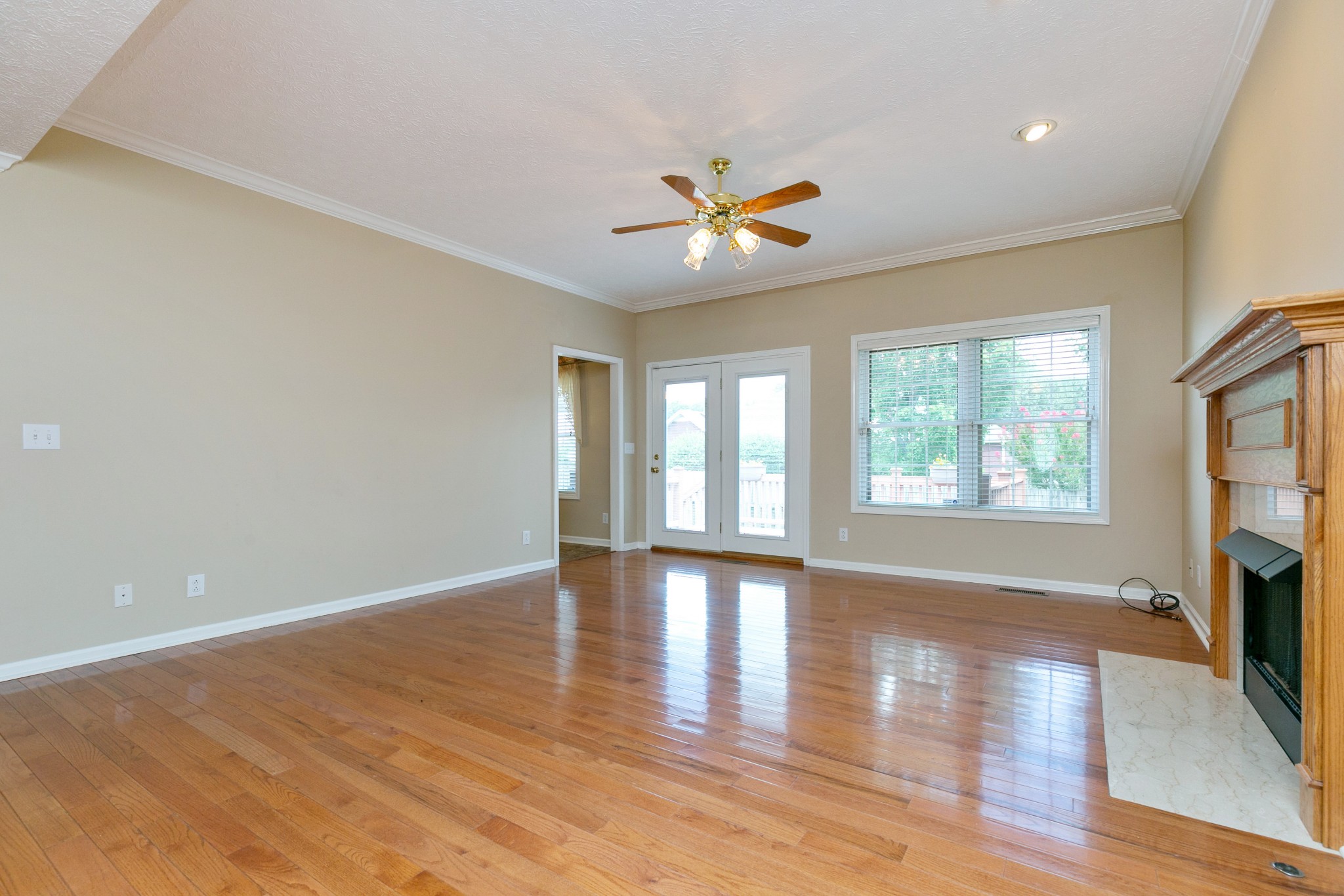 121 Foxrun Springfield, TN 37172 - Photo 4 of 36 a view of an empty room with a window and wooden floor