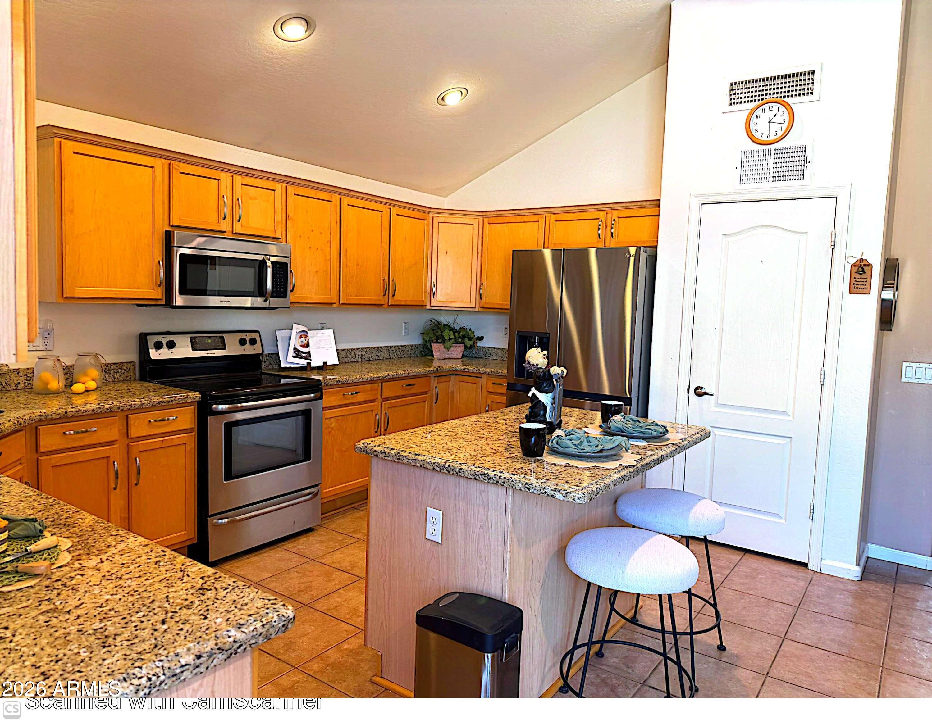 11058 East Cholla Road Mesa, AZ 85207 - Photo 2 of 22 a kitchen with stainless steel appliances granite countertop a stove a sink and a microwave