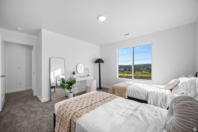 2123 Wolverine Way, Unit 2437 Washington, UT 84780 - Photo 32 of 40 Bedroom featuring neutral carpeting, white walls, and a large window overlooking a distant landscape