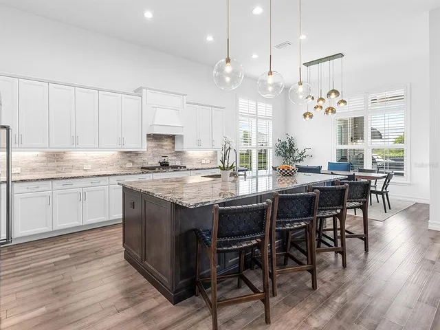 a bedroom with a bed a dresser and next to a window