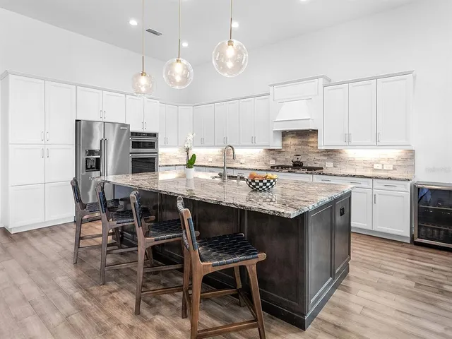 a bedroom with a large bed and a chandelier