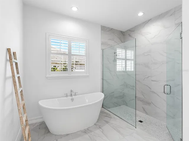a bathroom with a granite countertop sink mirror and a toilet