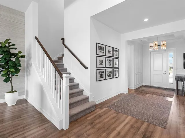 a living room with furniture a flat screen tv and a large window