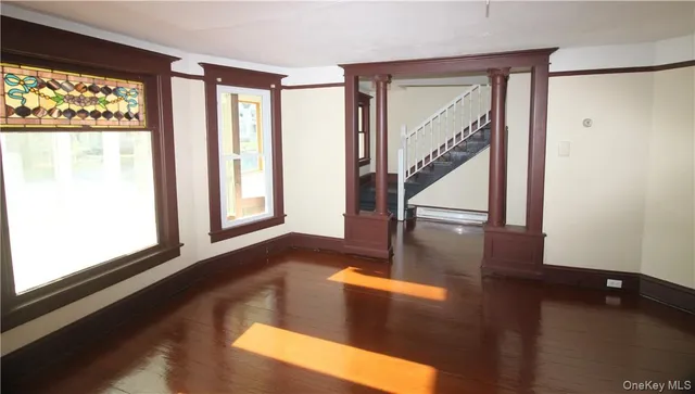 a view of an entryway with wooden floor