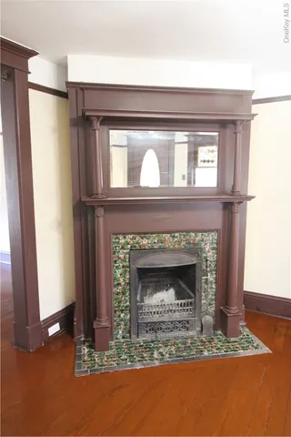 a view of a hallway with wooden floor and a living room