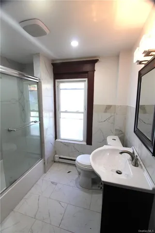 a bathroom with a shower and a bath tub