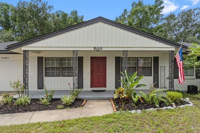 a front view of a house with a garden