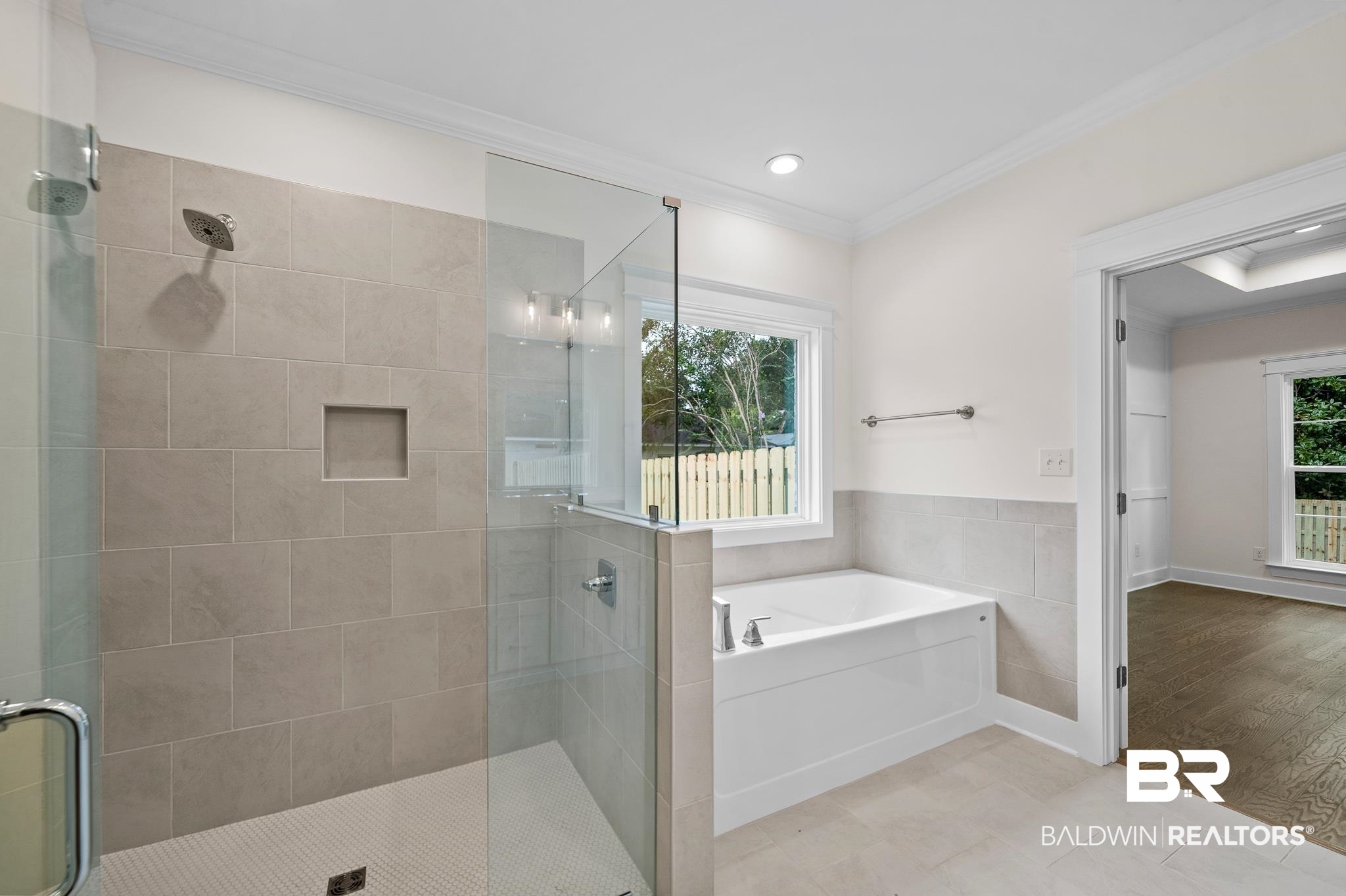 29 Signal Hill Road Daphne, AL 36527 - Photo 24 of 36 Bathroom featuring plus walk in shower, hardwood / wood-style flooring, plenty of natural light, and crown molding