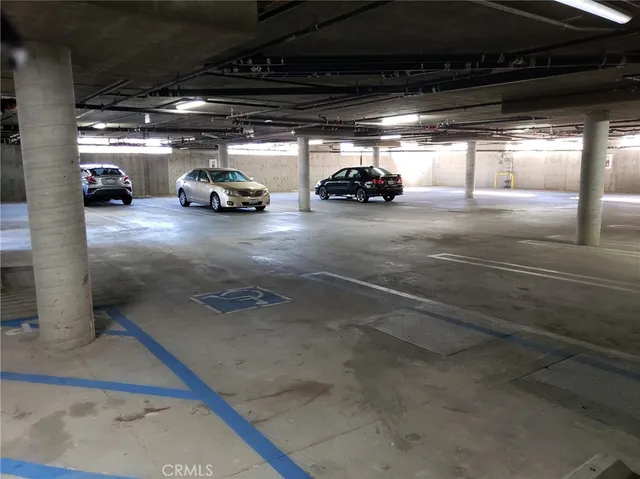 a view of parking garage with cars