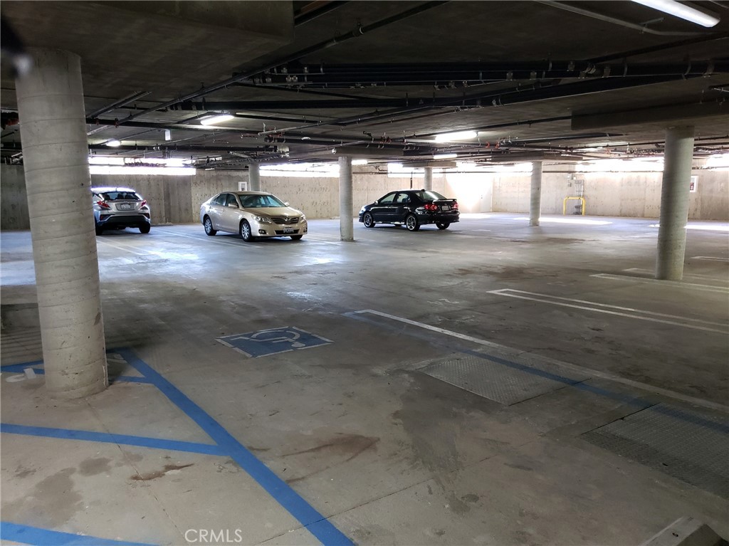 2651 South Hobart Boulevard, Unit 6 Los Angeles, CA 90018 - Photo 7 of 8 a view of parking garage with cars