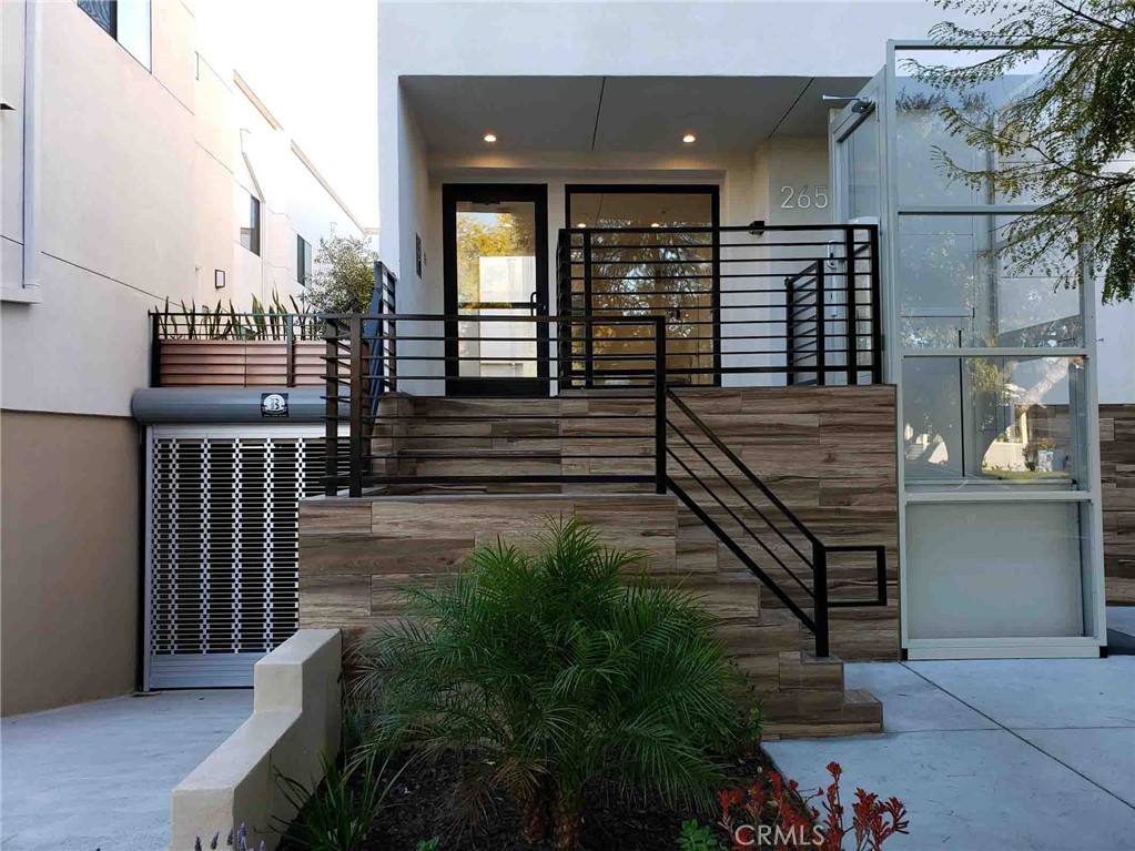 2651 South Hobart Boulevard, Unit 6 Los Angeles, CA 90018 - Photo 8 of 8 a view of a balcony with stairs and wooden floor